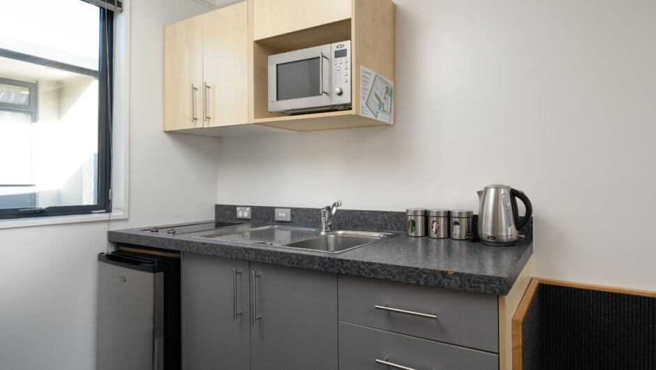 Executive Studio Kitchenette - features stovetop, fridge, microwave, crockery &amp; cutlery and all the basics for preparing simple meals.