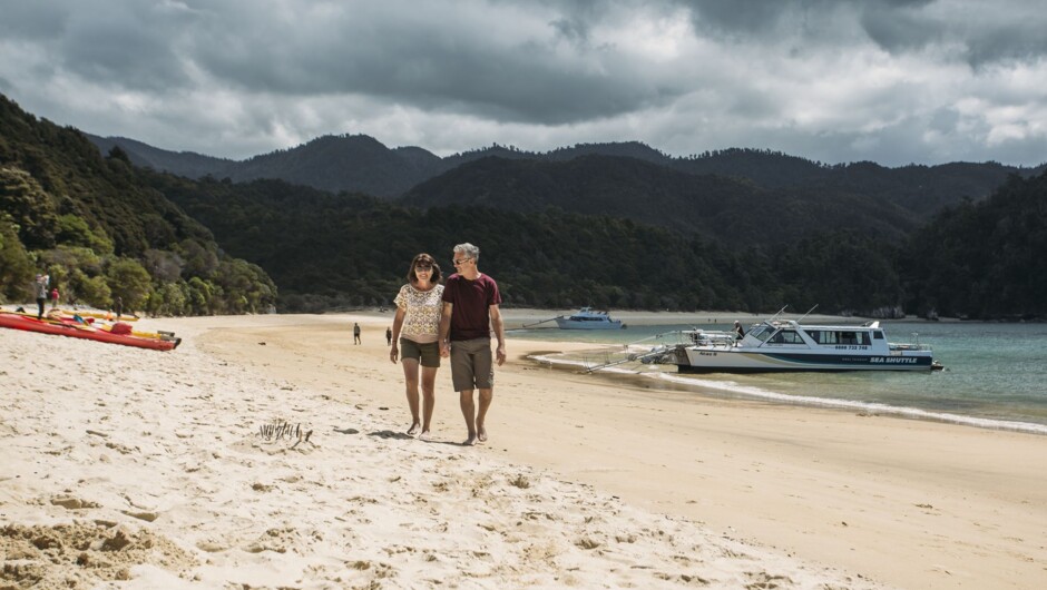 Couple strolling on Anchorage Beach in Abel Tasman National Park