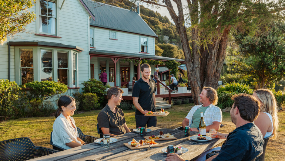 Outdoor dining surrounded by historic gardens and coastal calm