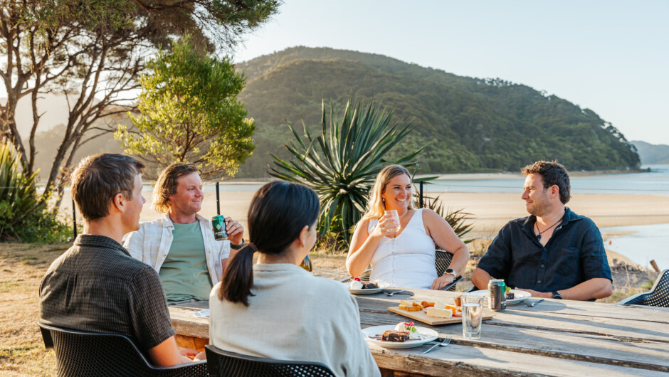 Outdoor beachfront dining with uninterrupted views over the inlet