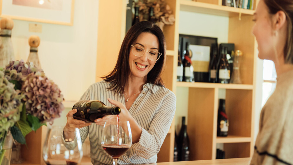Cellar Door Host pouring Pinot Noir for a guest