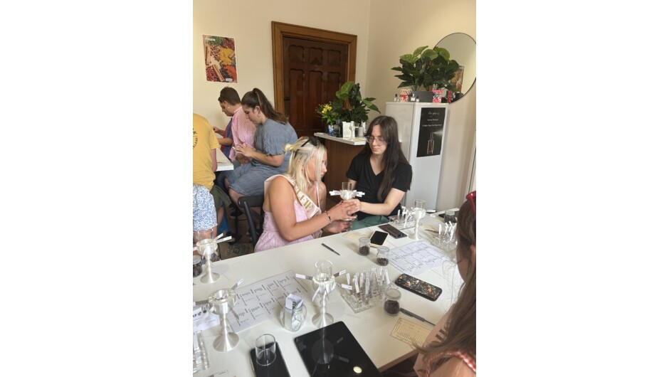 A staff member advises on a fragrance design