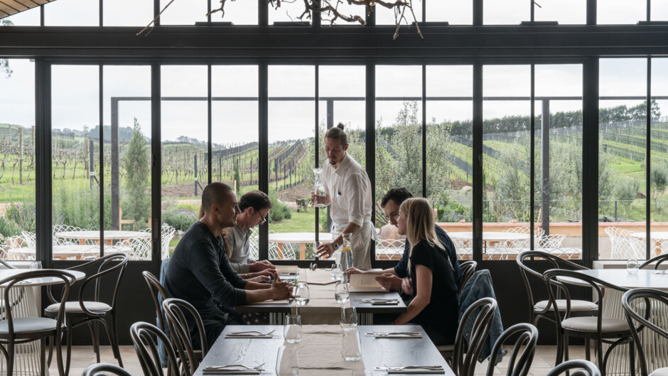 Step into our Spanish-inspired, architecturally designed space, where timeless elegance meets modern warmth. Surrounded by vineyards, landscaped gardens, and flourishing wetlands, the restaurant perfectly harmonises with the natural beauty of Waiheke Isla