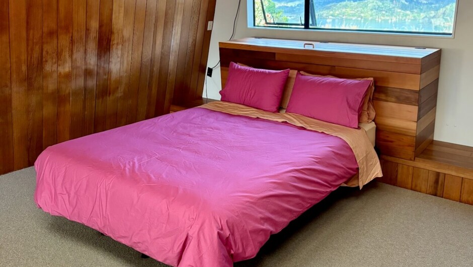 Queen bed on the open-plan mezzanine