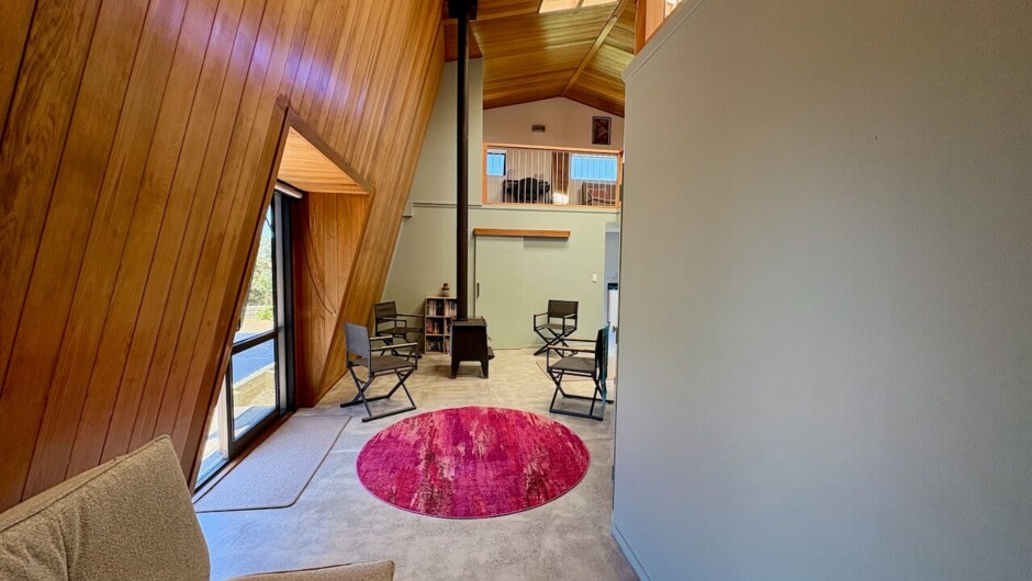 Entrance way with waxed concrete floors, sofa bed to the left
