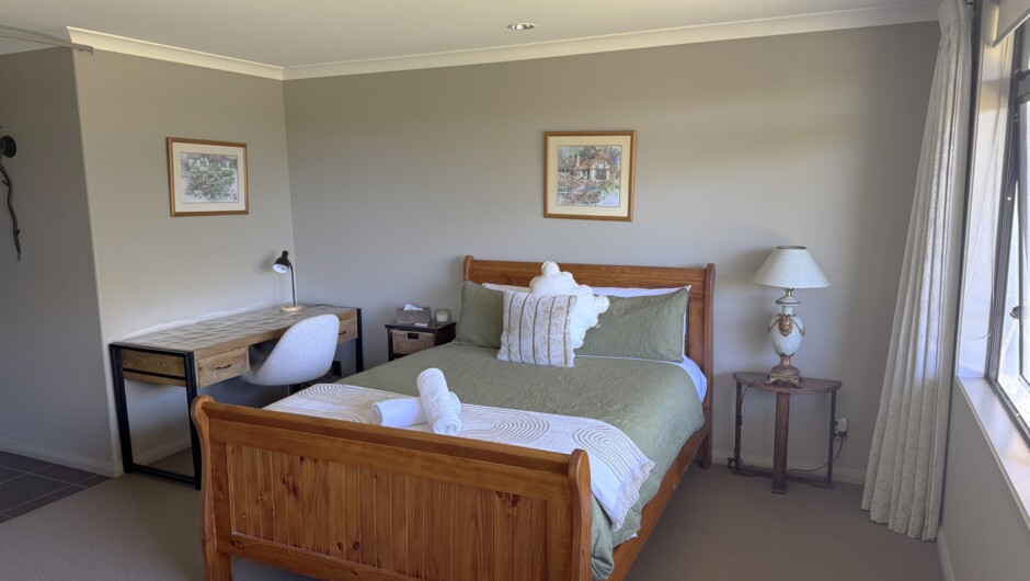 Main bedroom queen bed with work desk