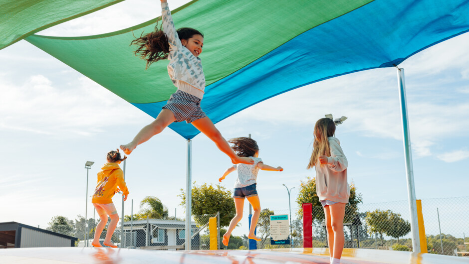 Children playing on the mega bouncy pillow at Tahuna Beach Holiday Park