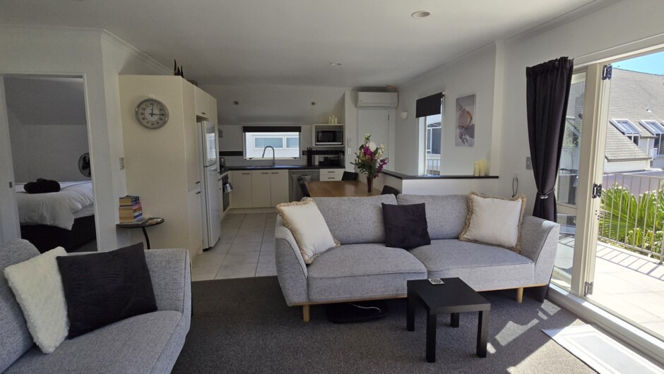 Open plan living, dining, kitchen, outdoors