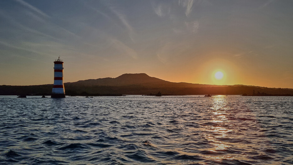 Sunrise over the iconic Rangitoto Island and lighthouse