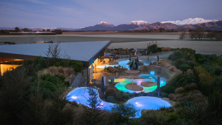 The Discovery Pools lit up at night.