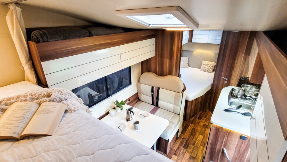 Our beautiful campervan Nelly boasts a large double bed over the driver cabin, another double bed on ground level and the dinette can be converted into a third small bed. Equipped with outdoor furniture, duvets and all cooking utensils, you just need to b