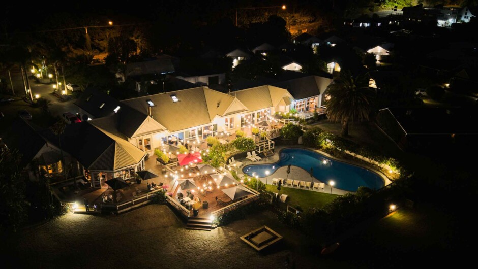 By night, The Sands transforms into a glowing waterfront retreat, where ambient lit, open-air dining creates an effortless relaxation atmosphere.