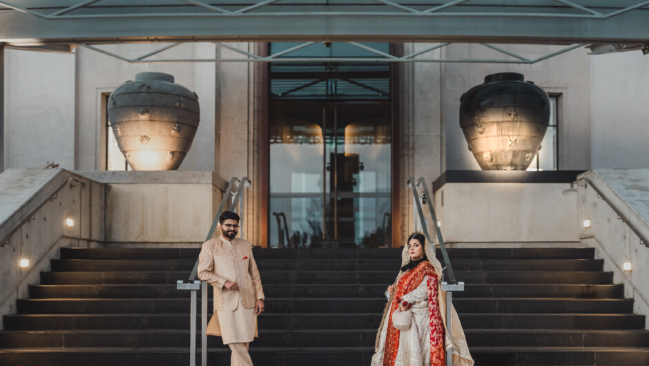Bride and groom on the wedding stairs, photographed by Illest Productions.