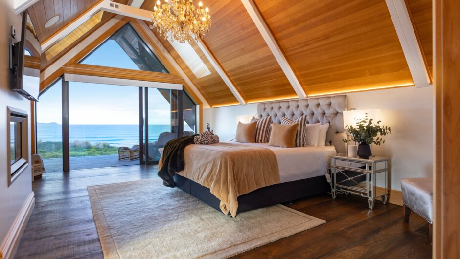 Beachfront Bliss Master Suite. Luxury beachfront view bath, ensuite, walk-in robe, gas fireplace, TV, and private balcony with sweeping, uninterrupted Pacific Ocean views.