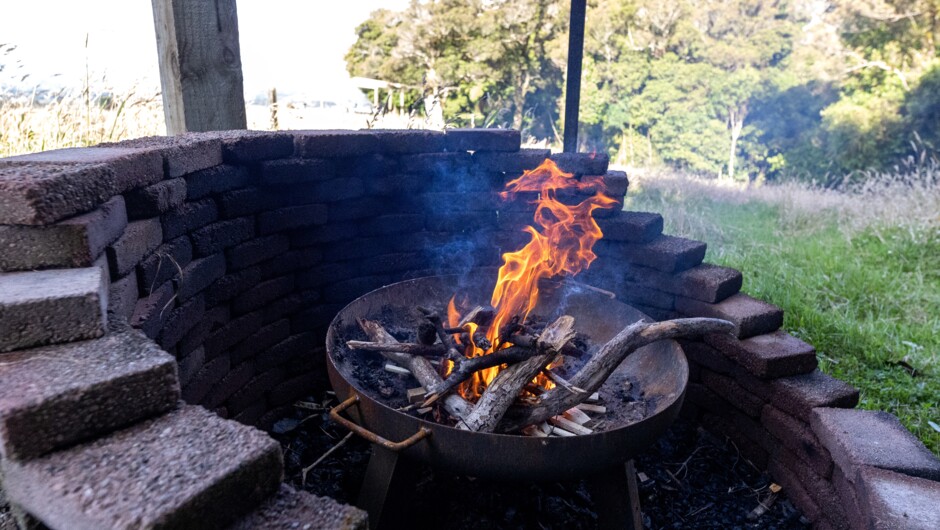 A covered, outdoor fire pit creates warmth no matter what the weather
