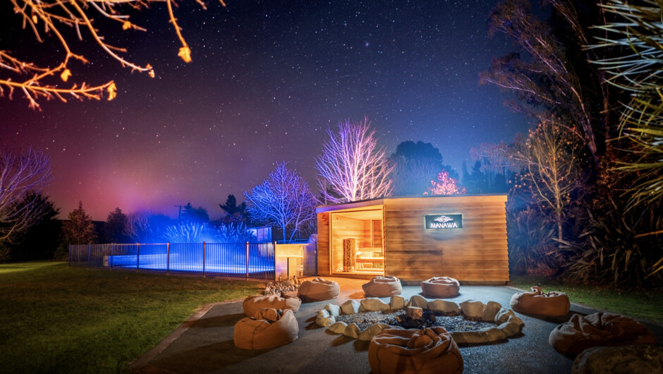 A quiet night at Manawa, with sauna, firepit, and outdoor spaces beneath the stars.