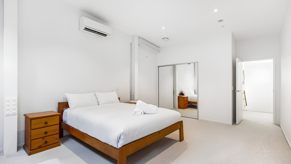 Spaced bedroom in queen-size bed and wardrobe