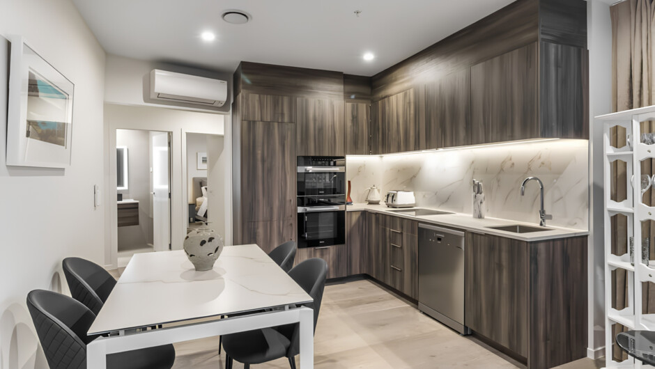 Functional kitchen equipped with oven, stove, microwave, fridge, and dishwasher