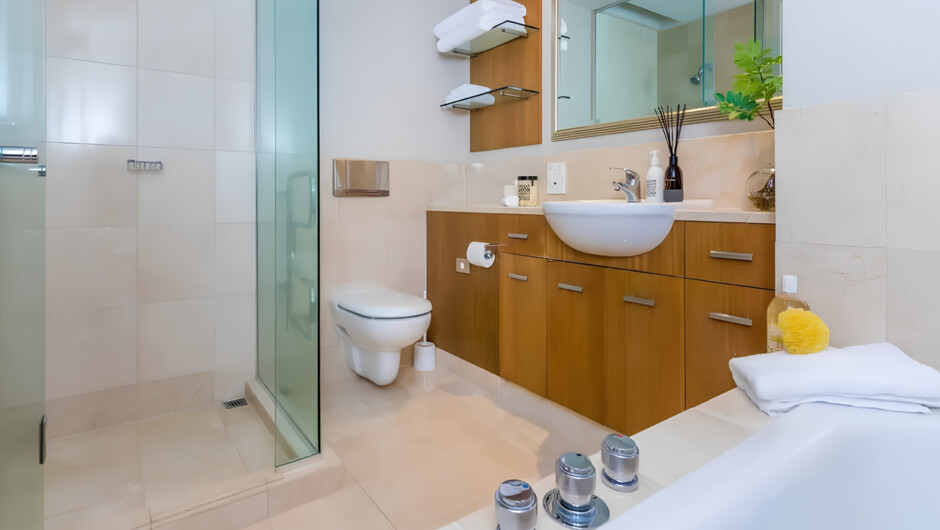 Modern bathroom with bathtub, towels, and toiletries