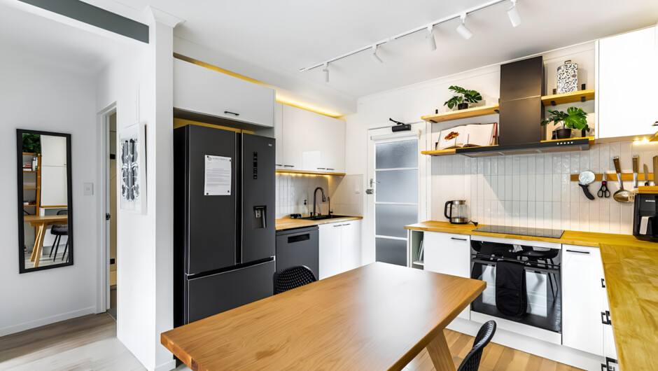 The apartment is designed with an open layout concept that creates a seamless flow between the living, dining, and kitchen areas