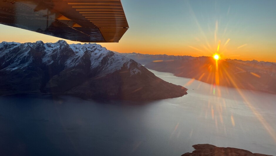 Golden hour light over Lake Wakatipu on an Air Milford scenic flight from Queenstown