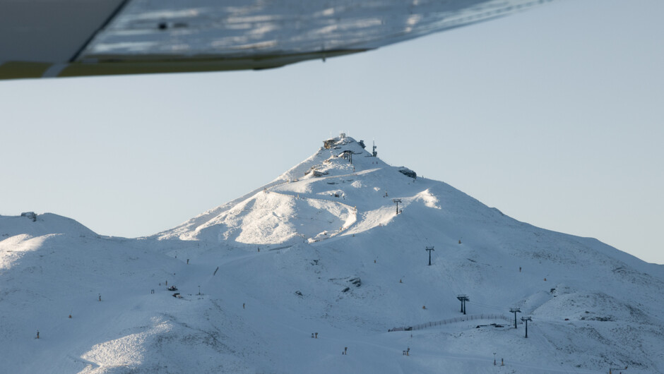 Coronet Peak ski field coming into view from above on Air Milford’s flight