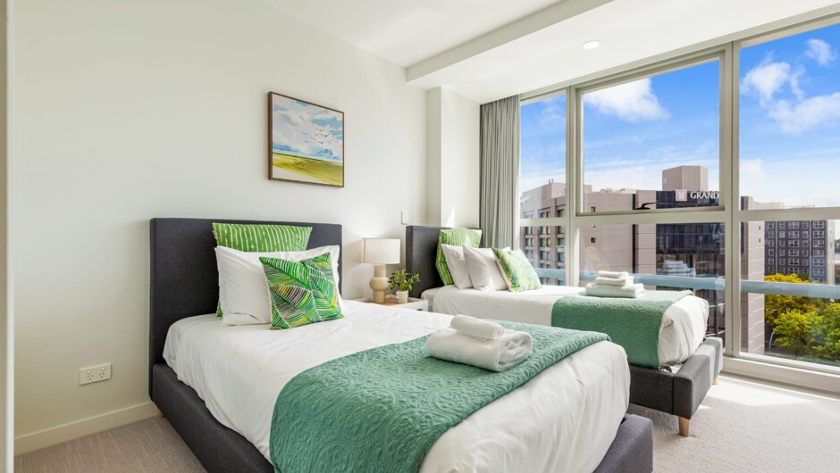 This spacious bedroom features 2 single beds