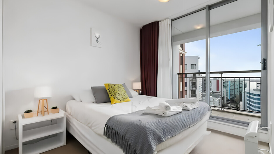 One of the 2 bedrooms featuring a direct access to the balcony.