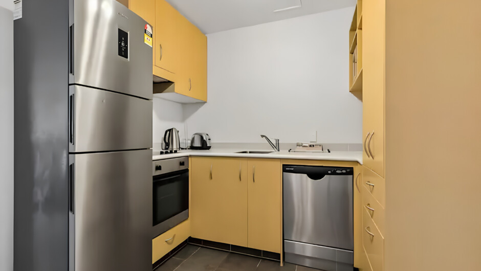 The kitchen is Fully functional and equipped with modern appliances, including an oven, microwave, and dishwasher for ultimate convenience