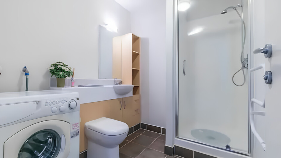 The toilet and bath also includes a washer/dryer
