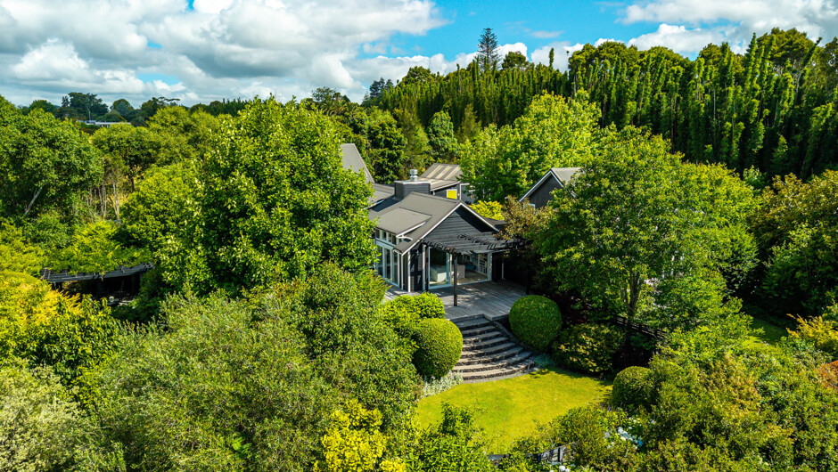 Aerial view of Treghan Lodge showing private guesthouses, landscaped gardens and native bush just minutes from Kerikeri in the Bay of Islands.