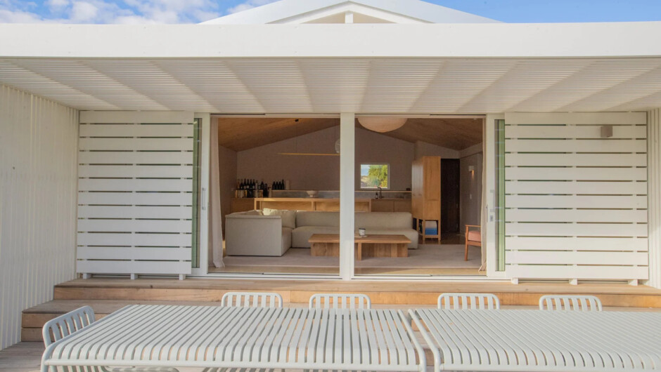 Outdoor dining on the deck, flowing straight into the open-plan living area