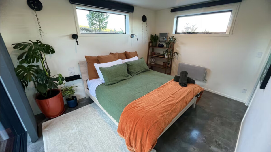 Bedroom with comfortable king bed, TV, record player &amp; heater