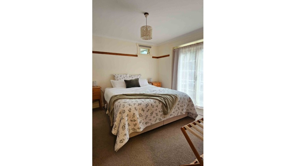 Spacious bedroom with a comfortable king-size bed.