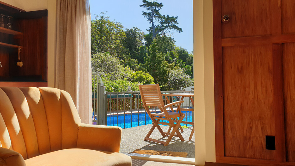Private deck overlooking the pool and garden.