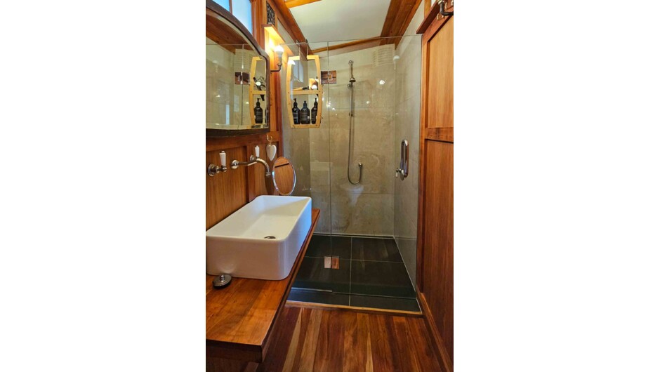 Warm timber bathroom with a spacious walk-in shower.