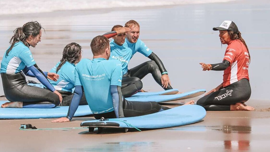 A group surf lesson on the sand at Sumner Beach, Christchurch, before heading into the waves.