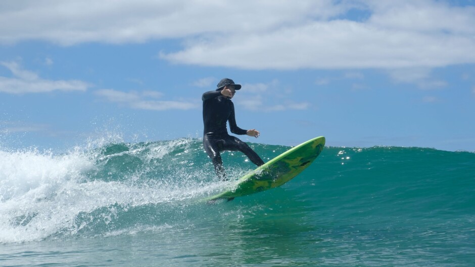 One of our guests up and surfing on Sumner's long, gentle beginner waves.