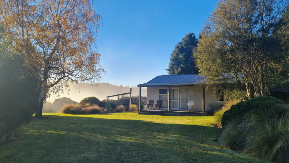 Benlea Cottage and front lawn on a foggy morning looking across to Snowy Peak.