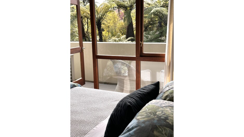 Okuta Bay Retreat - 2-Bedroom Garden View Suite.  Bedroom overlooking gardens with door opening onto private balcony