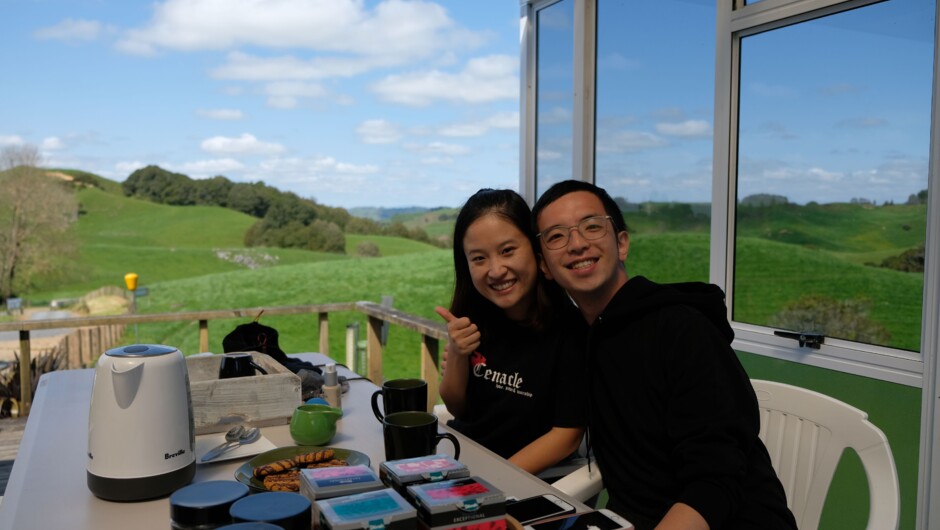 Guests enjoying a hot drink after their small-group glowworm cave tour at Down to Earth Waitomo.