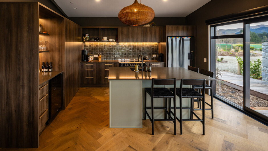 Fully provisioned chef's kitchen with high-end appliances, breakfast bar, and wine fridge and bar fully stocked.