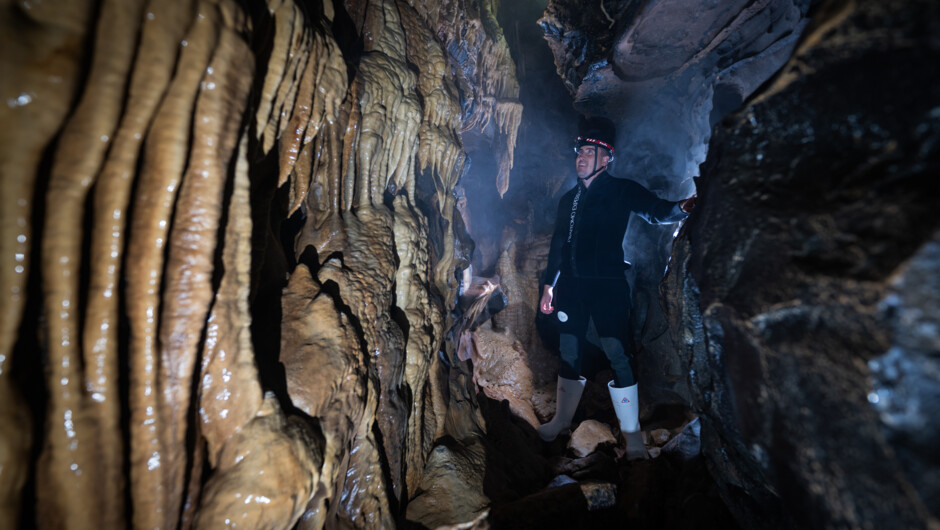 Climb through flowstone lined passages