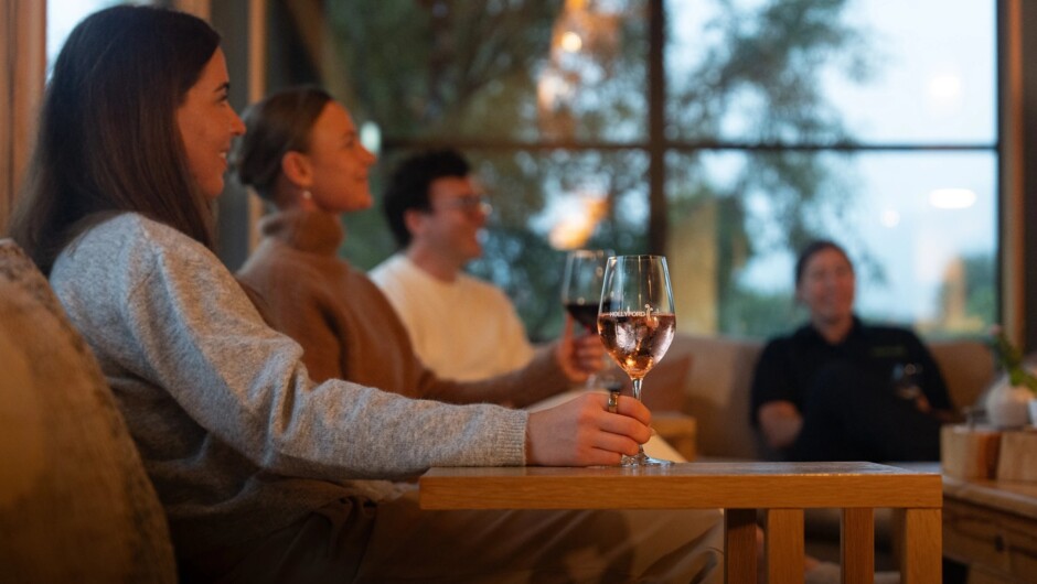 Connect with fellow guests over local New Zealand wines in comfortable lodges