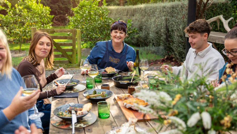 Chef Fiona and guests sharing a meal cooked together from fresh ingredients