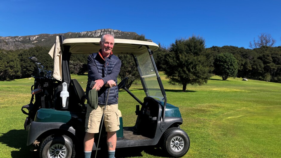 Golfer Tommy Hunsdale with one of the club's electric golf carts