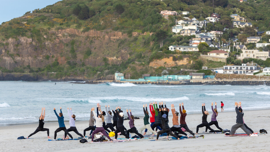Wild Dunedin New Zealand Festival of Nature, Sunrise Yoga on St Clair Beach, Dunedin. Looking south towards the St Clair Hot Salt Water Pool.