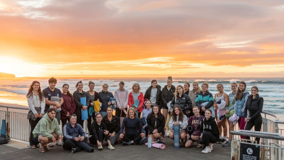 A group of participants enjoying Sunrise Yoga at St Clair Beach, Dunedin. A beautiful way to start the day as the sun rises over the ocean.