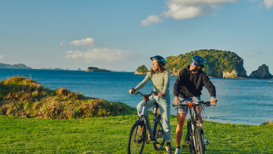 French couple on the water front at Tasman holiday resort, Hahei