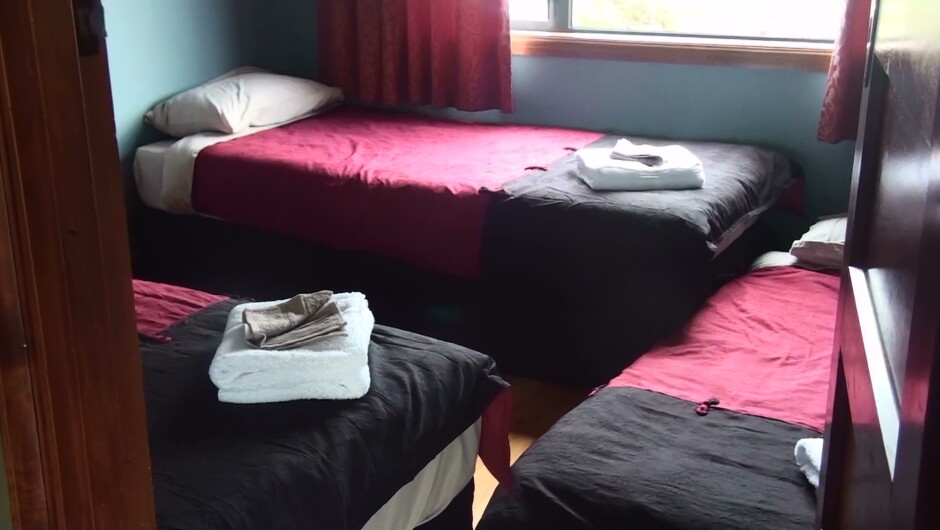 Waiau has 2 single beds that can become a king.  Can put a matress on the floor for a third child